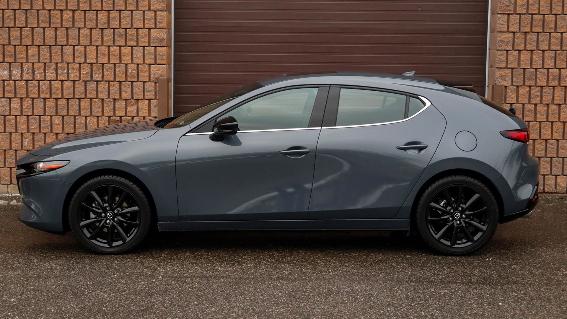 A side profile of a grey Mazda 3 Sport GT Turbo.