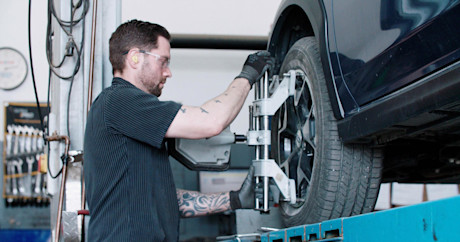 Editorial mechanic checking tire alignment 16 kal tire