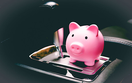Editorial pink piggy bank on gear shift money loan finance gettyimages 1369390027 rmcarvalho