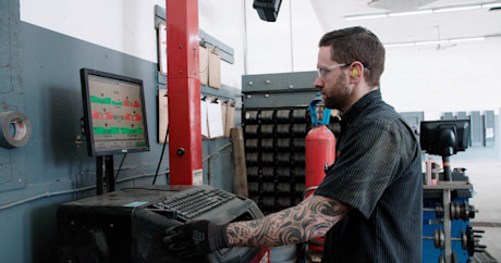 Editorial mechanic checking tire alignment 18 kal tire
