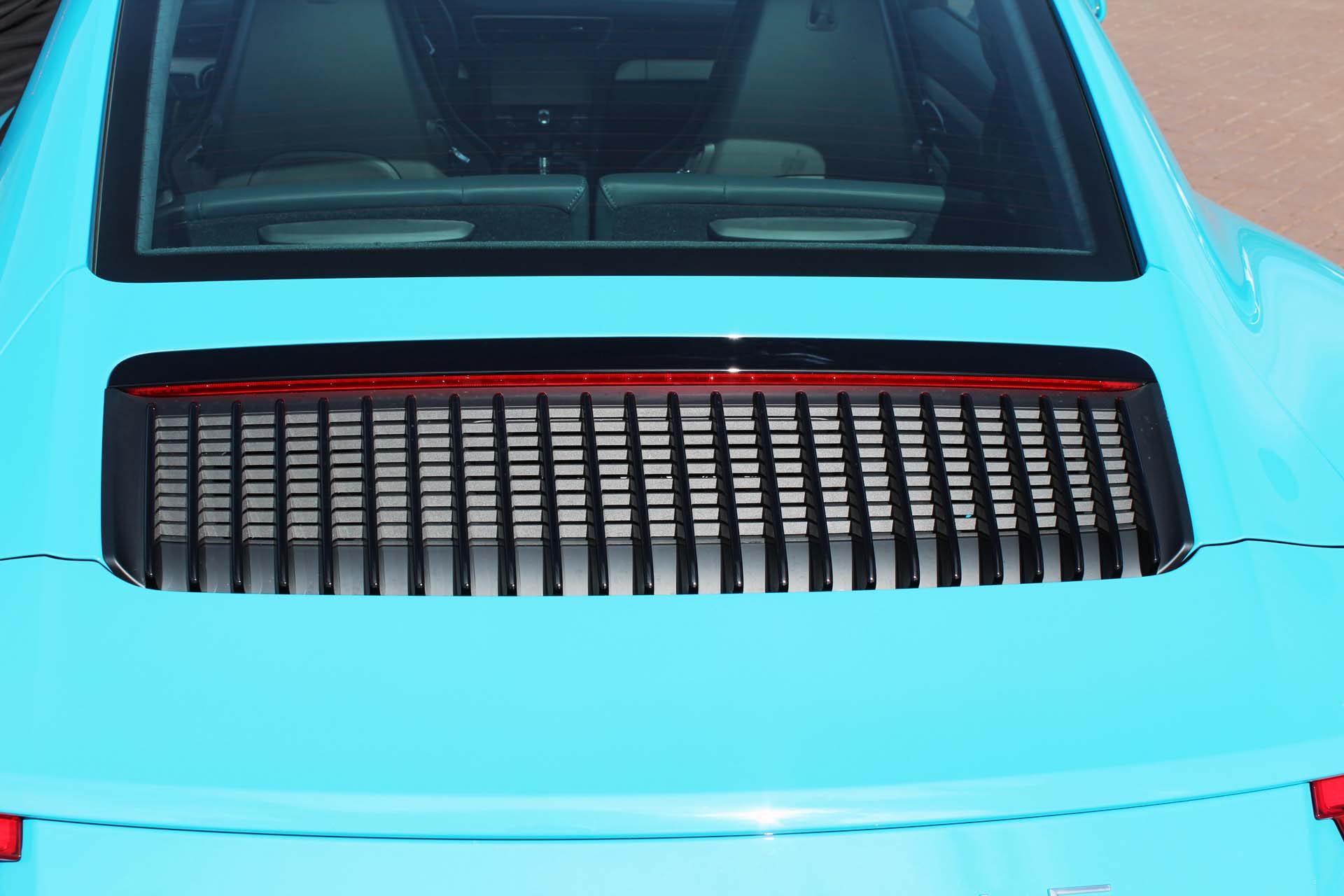 The engine cover vents now run north to south, and feed a pair of intercoolers, somehow crammed into the rear haunches.