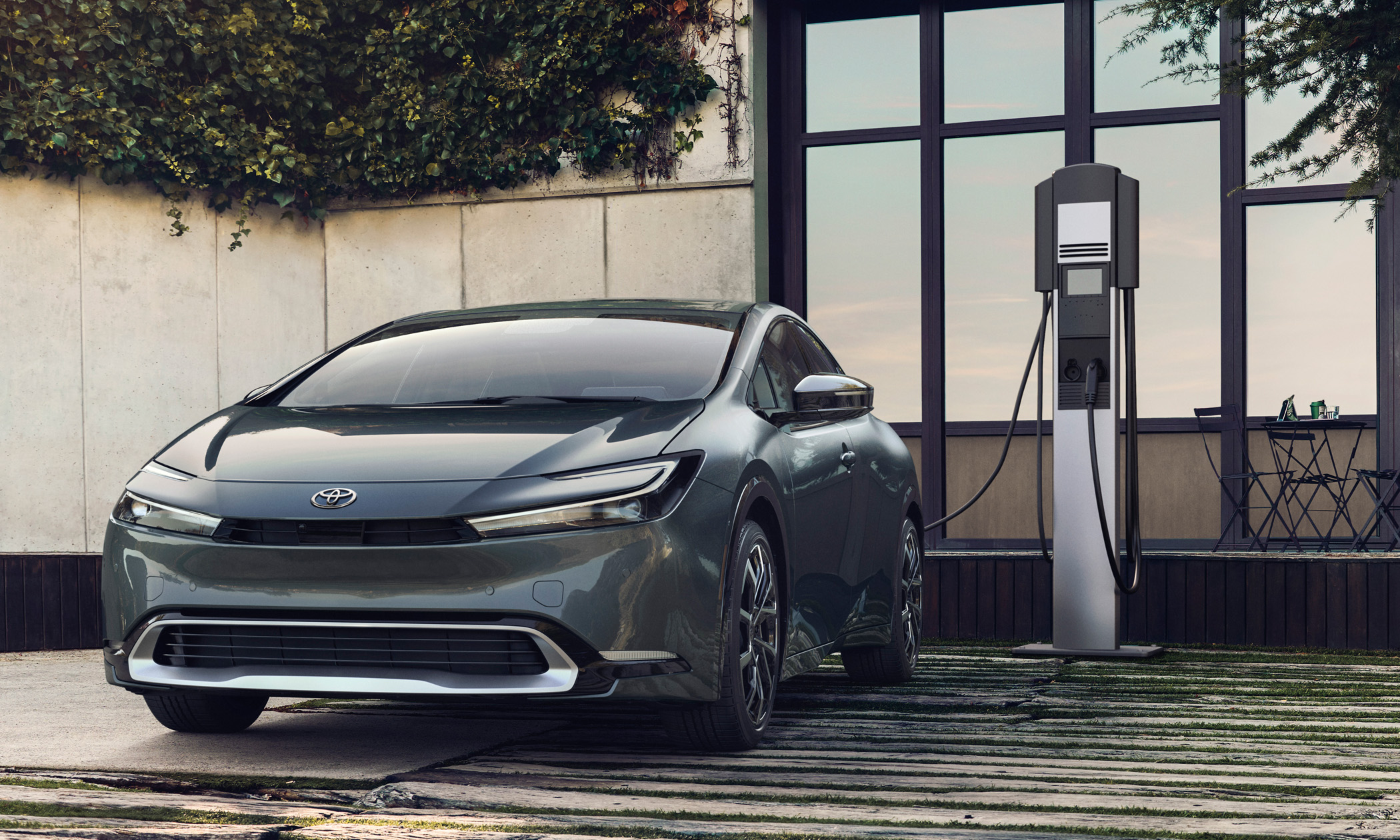 The Toyota Prius Prime is stationed before a charging station, highlighting its hybrid technology.