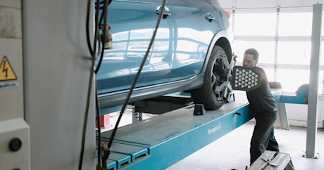 Editorial mechanic checking tire alignment 15 kal tire