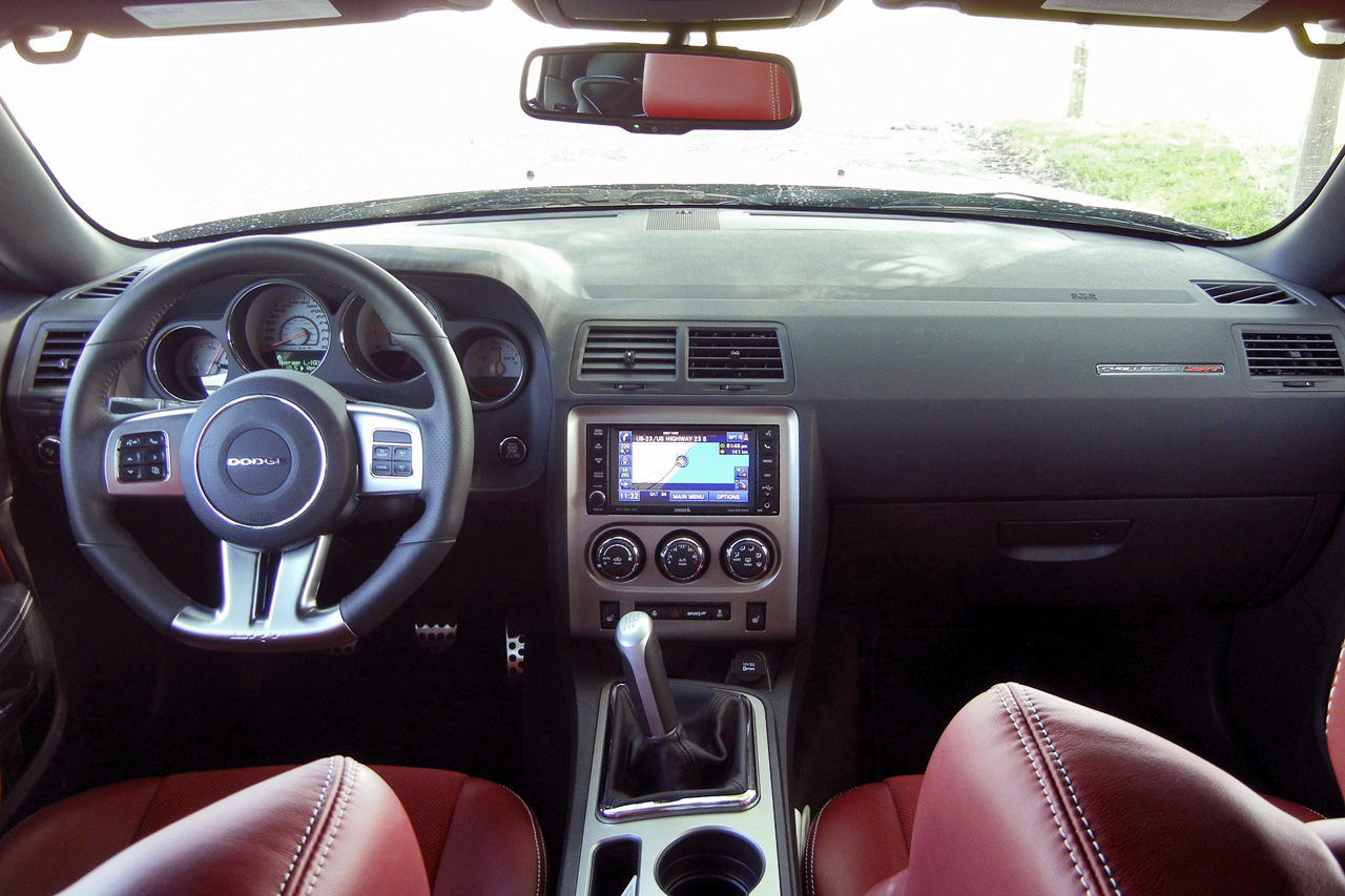 For its era and competition the Dodge Challenger interior was a good mix of features and functionality, offering amenities such as navigation, power seats, climate control, heated steering wheel and seats. Chrysler’s nifty audio controls on the back of the steering wheel spokes are supremely easy to toggle with your index fingers (rather than thumbs) with your hands on the wheel, allowing quick changes of volume and the satellite radio station – a huge perk on a long drive or slow commute. The splash of colour from the read seats also appealed to me, an excellent contrast with the dark grey exterior and black interior.