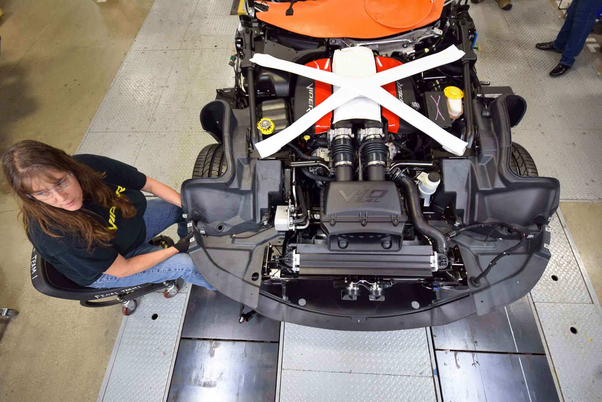 Once the Viper has been brought to life and validated, it heads over to Jill Braunschneider, who preps the Viper for the second part of its journey to completion. She installs special clips and other provisions to hold the Viper’s body, as well as close-out panels and other implements, to the completed frame structure. She wheels around the car in a roller-chair, installing dozens and dozens of small pieces of hardware to the incomplete car.