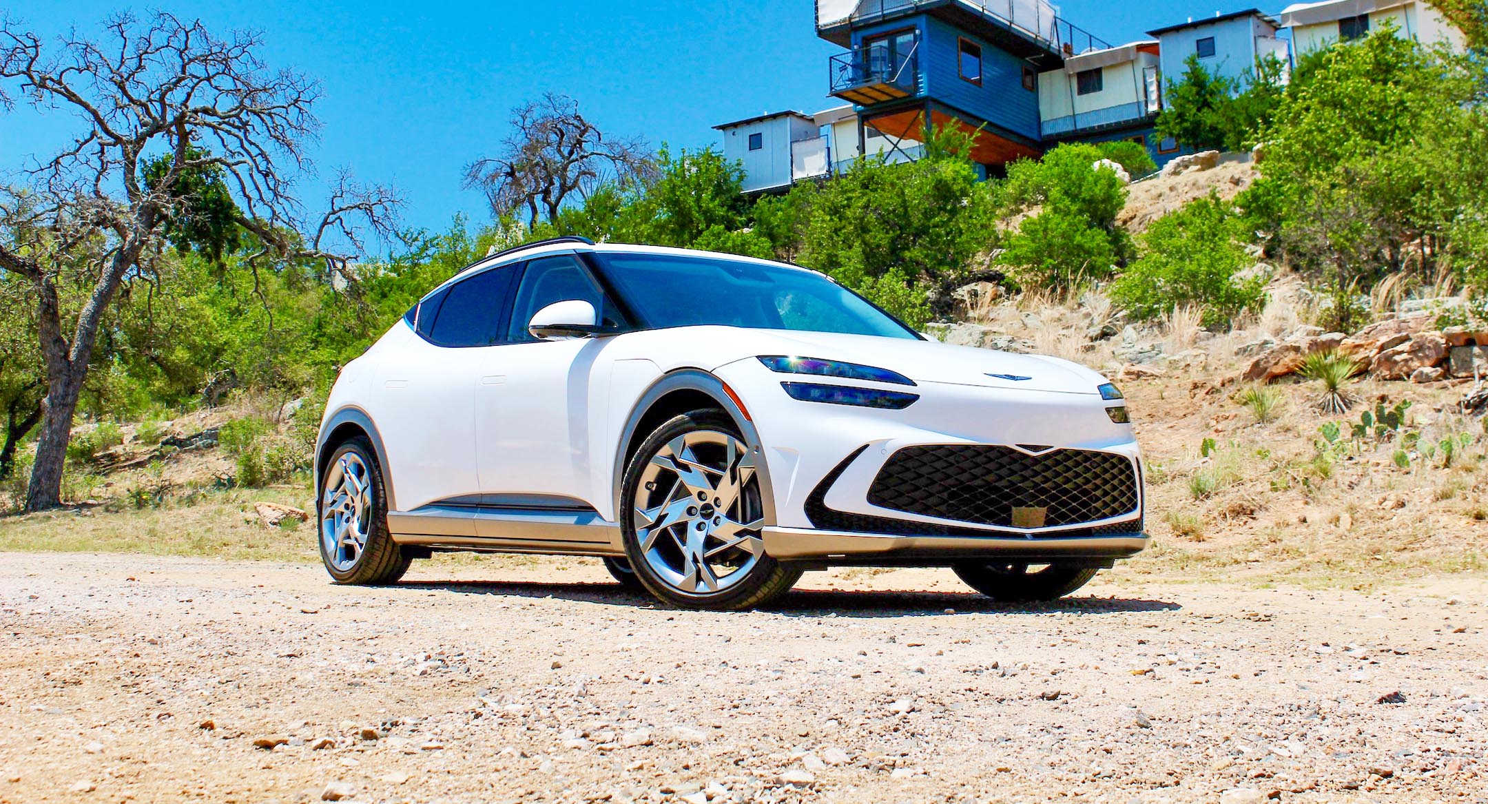 White 2023 Genesis GV60 Performance AWD on a gravel road